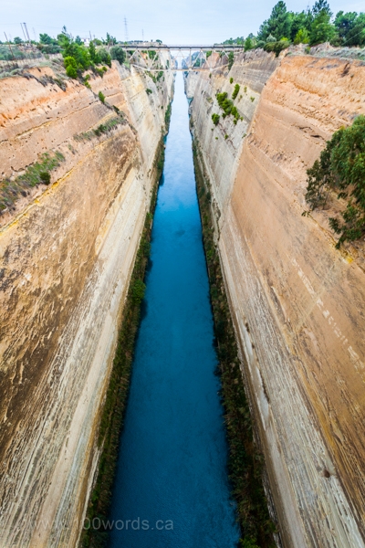 The Corinth Canal is a canal that connects the Gulf of Corinth with the Saronic Gulf in the Aegean Sea. It cuts through the narrow Isthmus of Corinth and separates the Peloponnesian peninsula from the Greek mainland, thus effectively making the former an island. The builders dug the canal through the Isthmus at sea level; no locks are employed. It is 6.4 kilometres (4 miles) in length and only 21.3 metres (70 feet) wide at its base, making it impassable for most modern ships. It now has little economic importance. The canal was envisioned in classical times and an initial effort was made to build it in the 1st century AD, but the project was aborted. Construction finally got underway in 1881 and was completed in 1893.