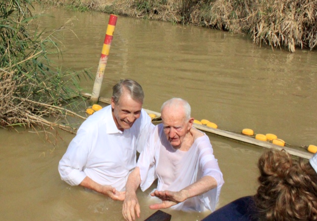 Just after baptizing 89-year-old Larry Burgess from Ottawa, Ontario, Canada. We are on the Israel side of Jordan. The reeds you see are in the Kingdom of Jordan. So much river water is used for irrigation that the river is much smaller than in Bible times.